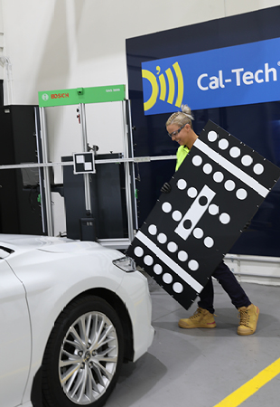 Technician preparing a car for ADAS Recalibration
